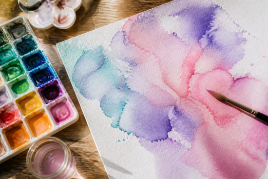 Watercolor palette and brush on paper with vibrant colors